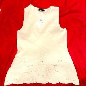 Ann Taylor flared knit top with cut out an embroidered trim on bottom